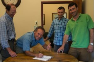 Orvis leaders signing the “Now or Neverglades” declaration. From left: president Bill McLaughlin, CEO Perk Perkins, brand director Simon Perkins, product developer Charley Perkins. Not pictured: Dave Perkins, executive vice-chairman.