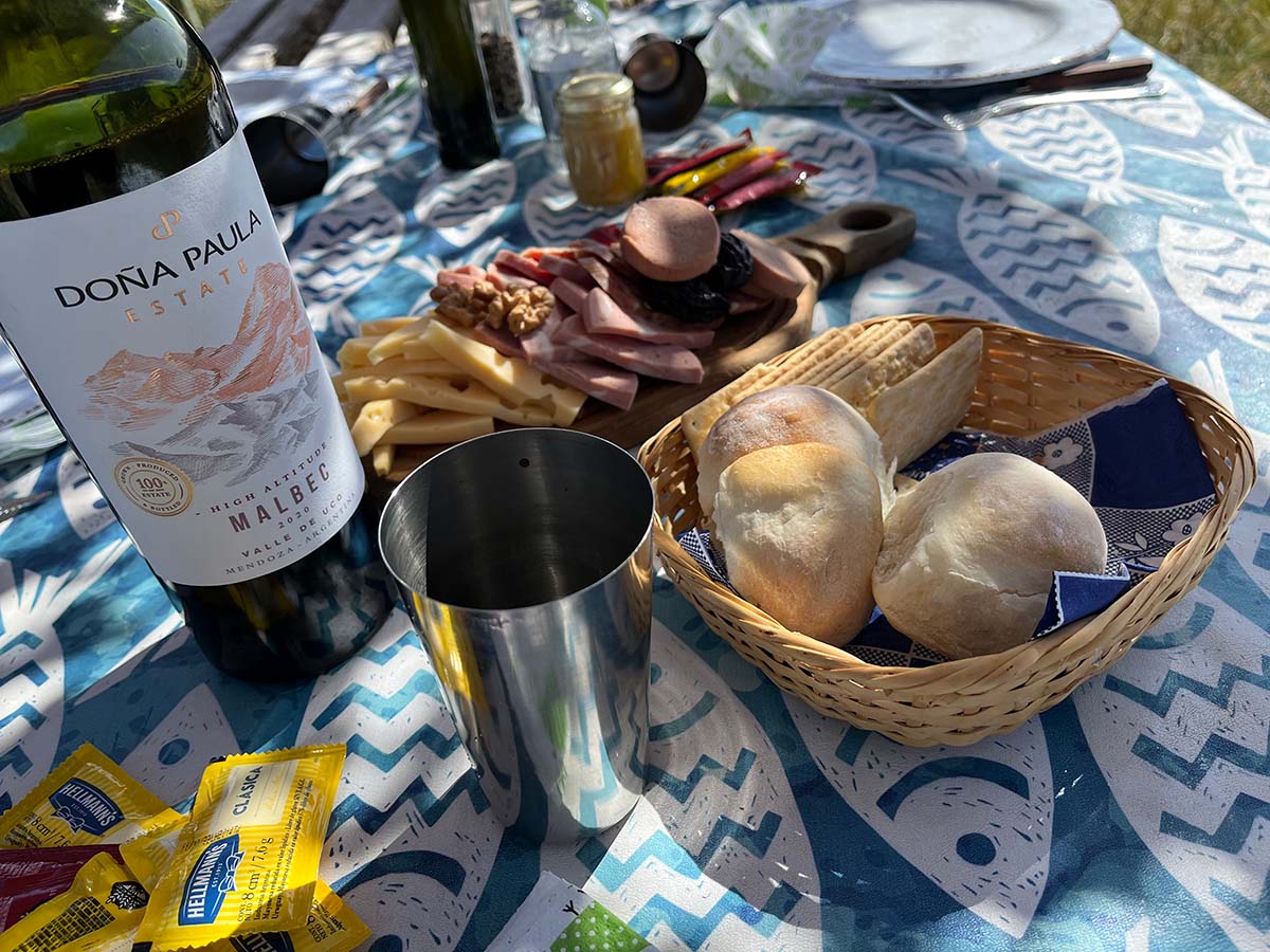 outdoor table set with food and wine